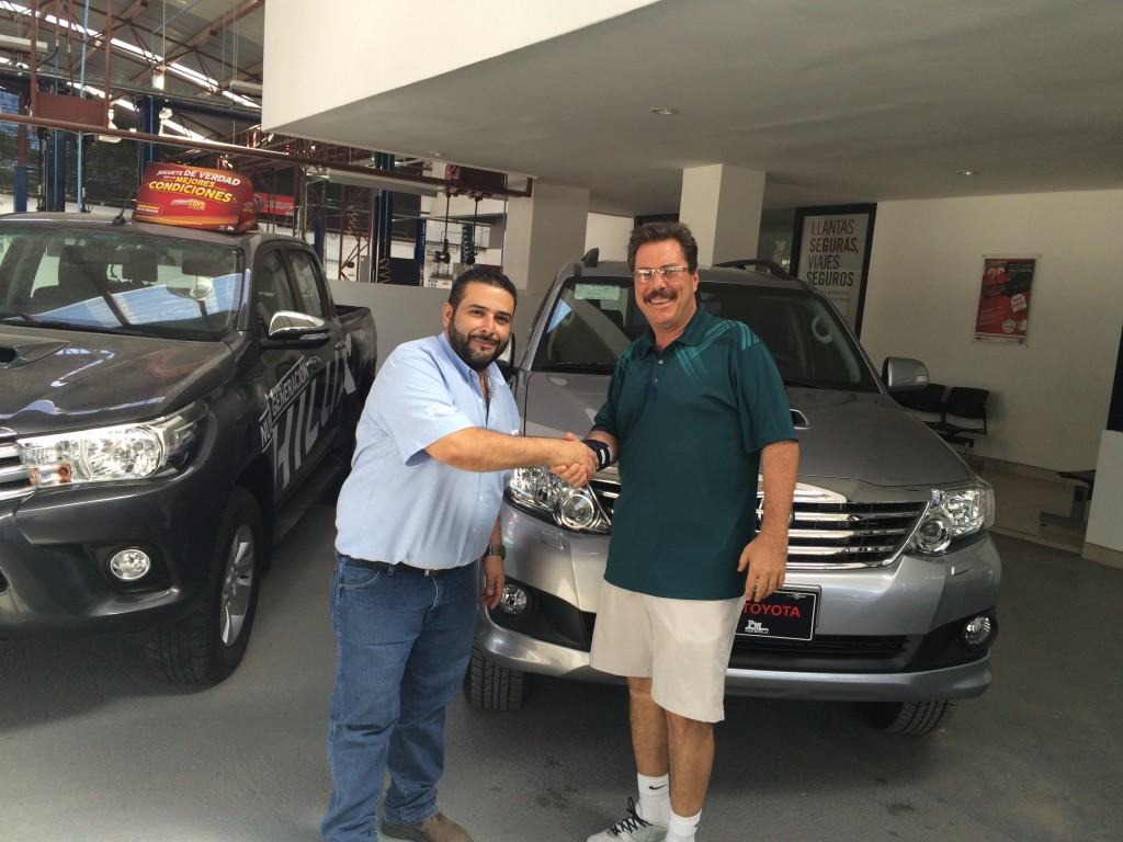 Dealer gives a buyer the keys to their new car in Costa Rica