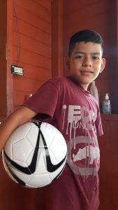 Young boy getting ready to play soccer on Children's Day in Costa Rica